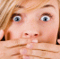 Closeup of young women covering her mouth with both hands on a white isolated background - Армавирский Собеседник